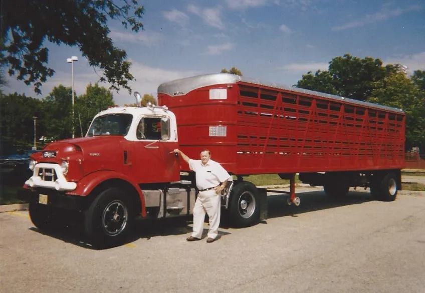 Bob McCoy Sr. in front of ared GMC truck